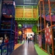 indoor big play structure with two girls laughing