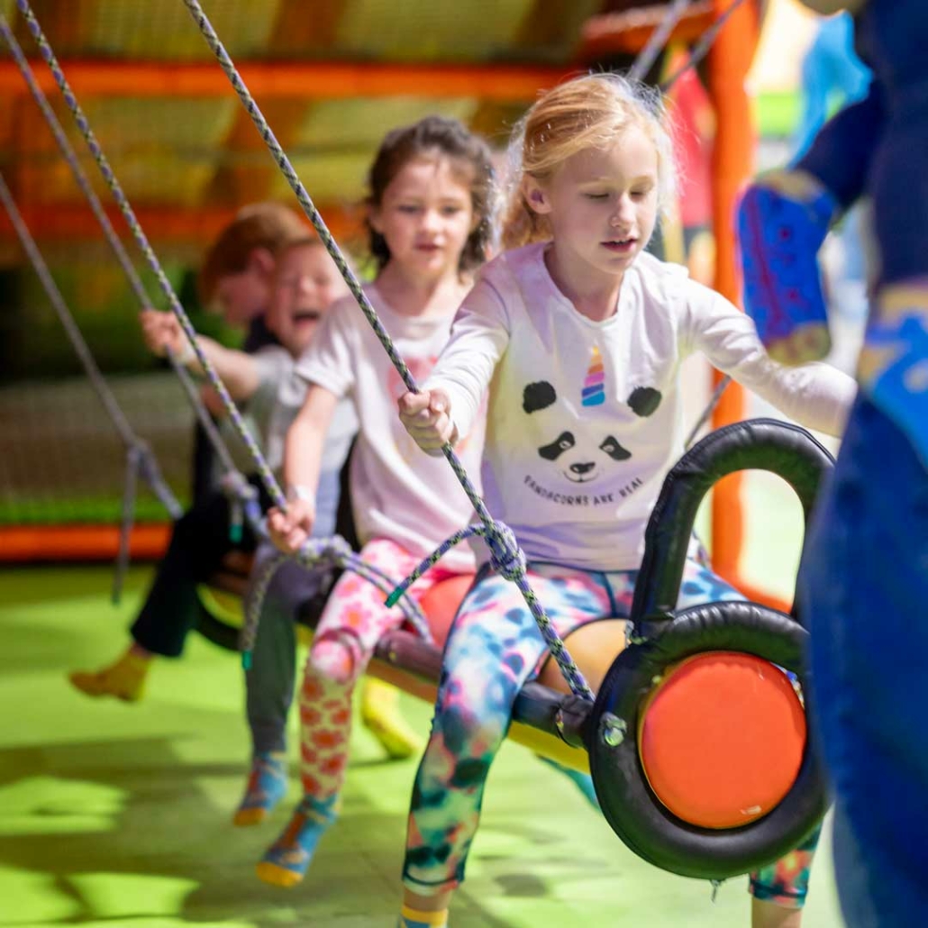 kids playing at an indoor playground during a birthday party