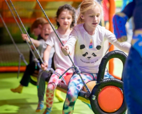 kids playing at an indoor playground during a birthday party